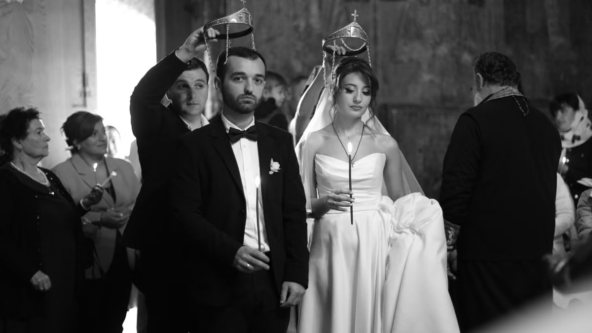 A traditional wedding ceremony with bride and groom, captured in striking black and white.